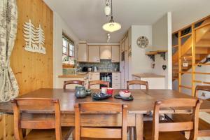 a kitchen and dining room with a wooden table and chairs at Triplex Overlooking The Village - Terrace & Bbq in Champéry