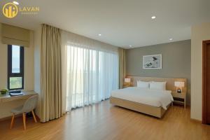 a bedroom with a bed and a large window at Garden View 5BR Villa - BBQ, FREE Parking, Marina Beach in Ha Long