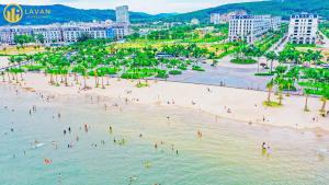 a group of people on a beach in the water at Garden View 5BR Villa - BBQ, FREE Parking, Marina Beach in Ha Long