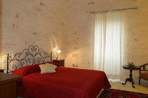 Postel nebo postele na pokoji v ubytování Relais Masseria Serritella