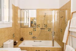 a bathroom with a bath tub and a shower at Visum Acropol ,3BR - Private Terrace-Jacuzzi - Amazing View in Athens
