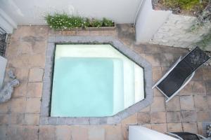 a swimming pool in the middle of a brick floor at Camps Bay Guest Suite with private pool in Cape Town