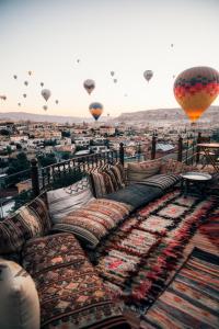 a bunch of hot air balloons flying over a city at Kelebek Special Cave Hotel & Spa in Goreme