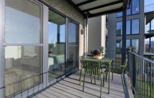 a balcony with a table and chairs on a balcony at Gorgeous Apartment In Lembruch-dmmer See in Lembruch