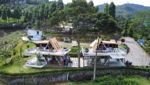 an aerial view of a house on a hill at De Pointé Resort & Resto in Campaka