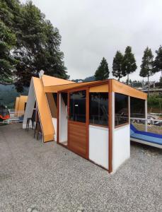 a small house with a roof on a boat at De Pointé Resort & Resto in Campaka