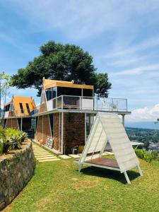 a house with a staircase in front of it at De Pointé Resort & Resto in Campaka