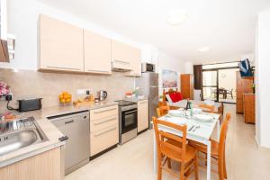 a kitchen and dining room with a table and chairs at Sea Bliss Studio Apartment close to the sea - by Getawaysmalta in St. Paul's Bay