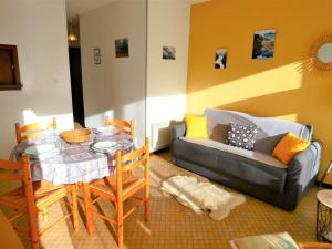 a living room with a table and a couch at Appartement Saint-Lary-Soulan, 2 pièces, 4 personnes - FR-1-457-218 in Saint-Lary-Soulan
