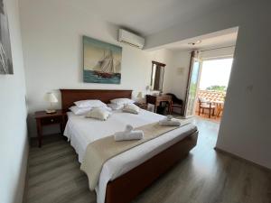a bedroom with a large bed with two towels on it at Soko Apartments & Rooms in Zaton