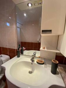 a bathroom with a sink and a toilet and a mirror at Denize 100 mt 2+1 merkezde daire in Alanya