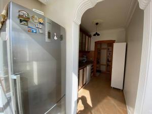a kitchen with a stainless steel refrigerator in a room at Denize 100 mt 2+1 merkezde daire in Alanya