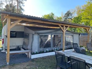 a pergola with a picnic table and a bench at Prestige Camping Brandenburg in Plaue