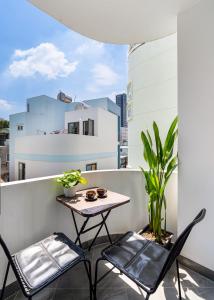 a small table and two chairs on a balcony at Jan Hostel Central Point in Ho Chi Minh City