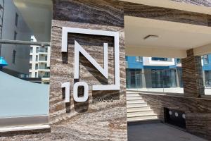 a sign on the side of a building with the number ten at Studio Melody Nord 10 in Năvodari