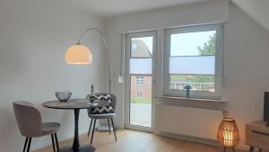 a dining room with a table and a window at Haus Polarstern Ferienwohnung Kapella in Borkum