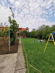 a yard with a playground with a yellow hose at Bar-Apartman 2 in Bar