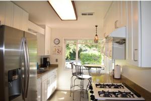 a kitchen with a refrigerator and a table with chairs at Palo Alto 1 Bedroom Near Stanford University in Palo Alto