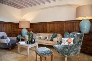 a living room with a couch and chairs and a table at Hotel Les Messugues in Saint-Paul-de-Vence