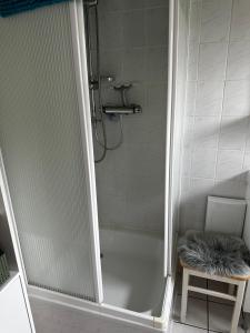 a bathroom with a shower with a white tub at Gästehaus in Senzig