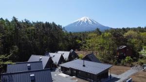 an aerial view of a snow covered mountain with houses at GRAN TOCORO. RESORT&GLAMPING in Narusawa