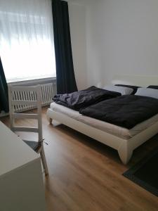 Schlafzimmer mit einem Bett und einem Fenster in der Unterkunft Helle 3 Zimmer Wohnung in Krefeld