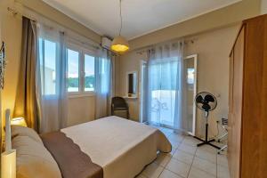 a bedroom with a bed and a room with a window at Corfu Stinados Apartment in Giannádes