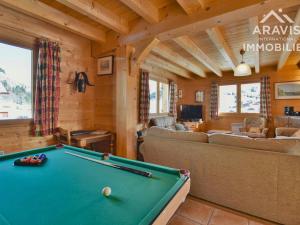 a living room with a pool table in a cabin at Chalet Le Grand-Bornand, 7 pièces, 12 personnes - FR-1-391-30 in Le Grand-Bornand