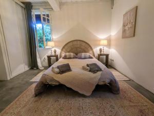 a large bedroom with a large bed with two lamps at Maison Pimoli : Chambre Garance in Soustons