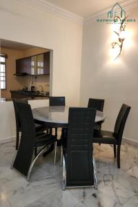 a dining room with a table and chairs at 99 Kelawei in George Town