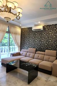 a living room with a large couch and a wall at 99 Kelawei in George Town