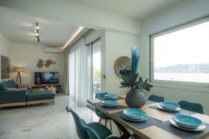 a living room with a wooden table and chairs at Nicolas Exclusive Apartment in Agios Nikolaos