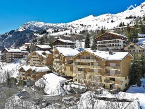 a group of buildings on a snowy mountain at Appartement Le Grand-Bornand, 5 pièces, 9 personnes - FR-1-391-93 in Le Grand-Bornand