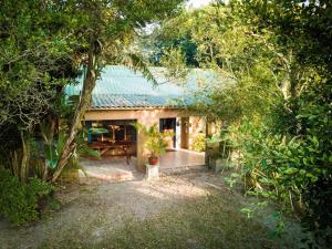 a house with a green roof in a forest at Kaia Homestead in Sodwana Bay