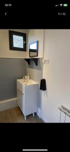 a small bathroom with a sink and a window at Petite maison chaleureuse des boucles de la Seine in Le Mesnil-sous-Jumièges