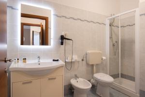 a bathroom with a sink and a toilet and a shower at Residence Rialto in Trieste
