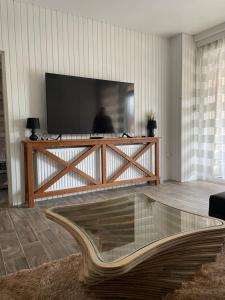 a living room with a large flat screen tv at Lake House Siófok in Siófok