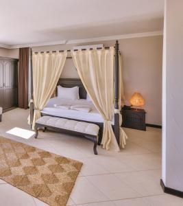 a bedroom with a bed with a canopy at Hill House Adult Only in Kaş