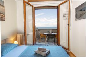 a bedroom with a bed and a view of a table at APARTMAJI PRI BOSI NOGI in Izola