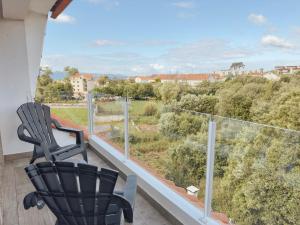 a balcony with a chair and a view at Apartamentos Avenida Areas in Sanxenxo +22 photos