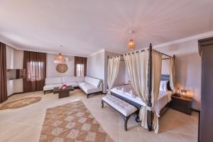a bedroom with a bed and a living room with a couch at Hill House Adult Only in Kaş +37 photos