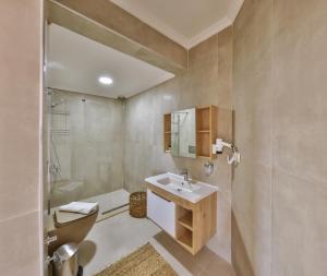a bathroom with a sink and a toilet at Hill House Adult Only in Kaş