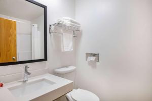 a white bathroom with a sink and a toilet at Super 8 by Wyndham Duluth in Duluth