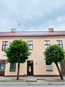 a building with two trees in front of it at Võru Studio Apartment in Võru
