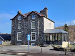 a large brick building with a gazebo in front of it at LLys Aeron Guest House in Aberaeron