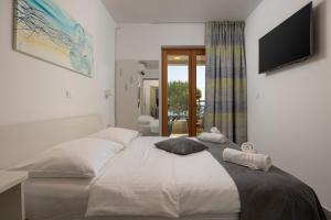 Postel nebo postele na pokoji v ubytování Apartments Lea