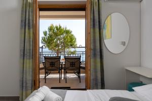 a bedroom with a view of a balcony with a table and chairs at Apartments Lea in Podstrana