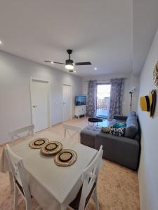 a living room with a table and a couch at Bonsol Solo Familias Serviplaya in Playa de Xeraco