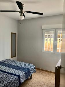 a bedroom with a bed and a ceiling fan at Bonsol Solo Familias Serviplaya in Playa de Xeraco