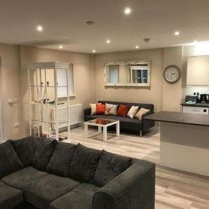 a living room with a couch and a table at Westmains Lodge in Callander